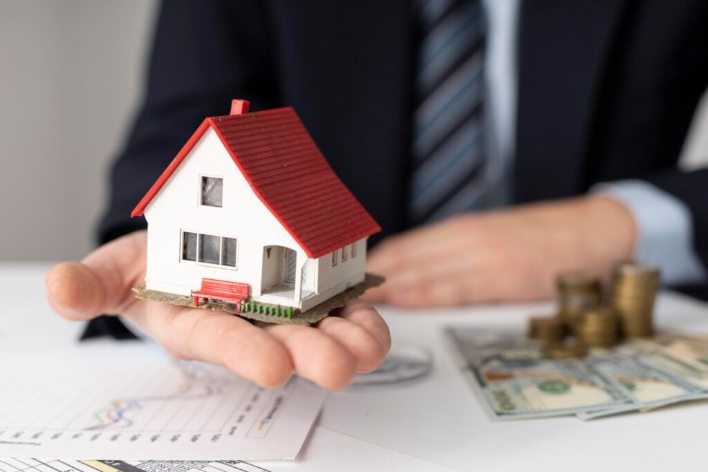 Oregon home with financial charts and growth arrows symbolizing long-term wealth building through smart mortgage strategies