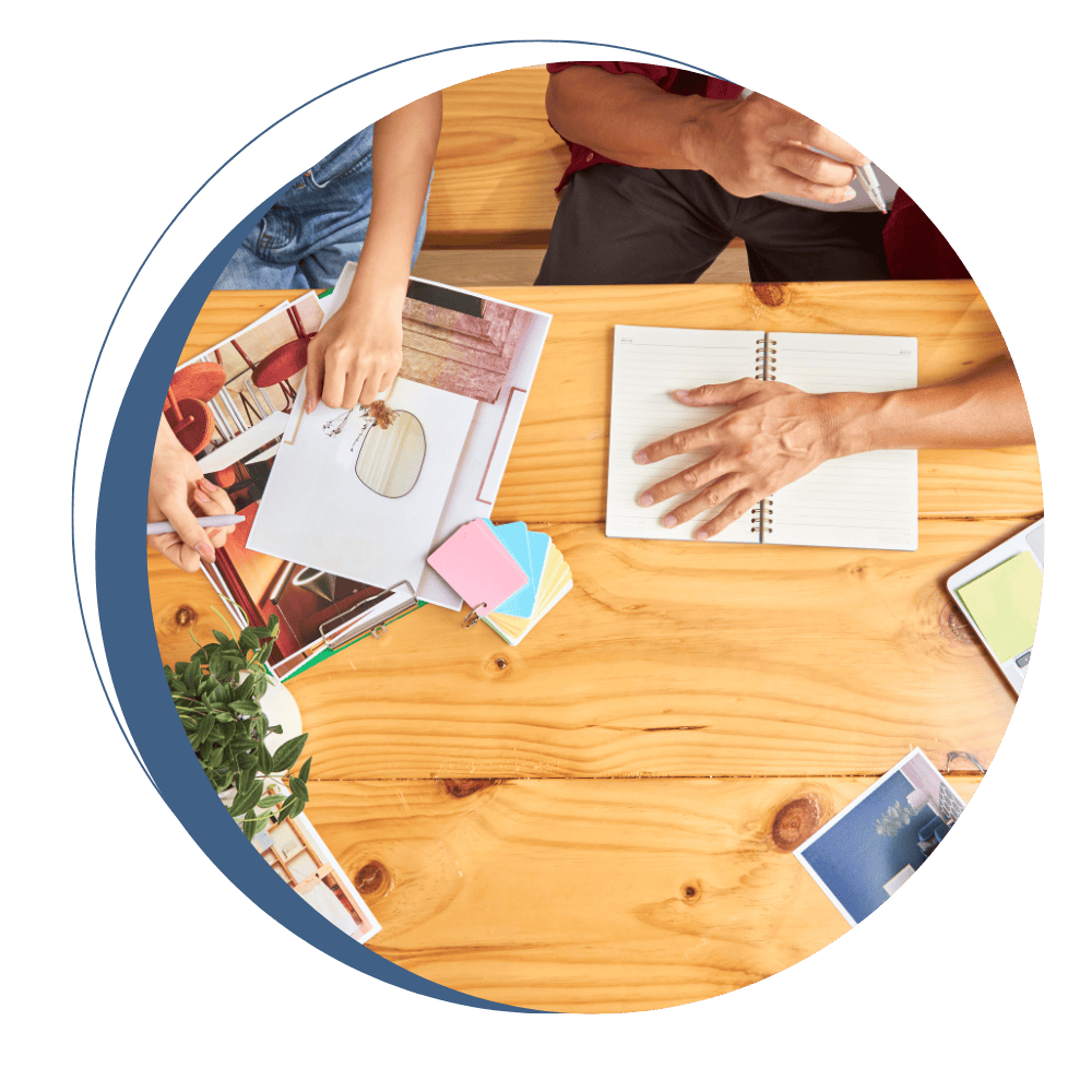 Hands arranging marketing materials and design samples on a table
