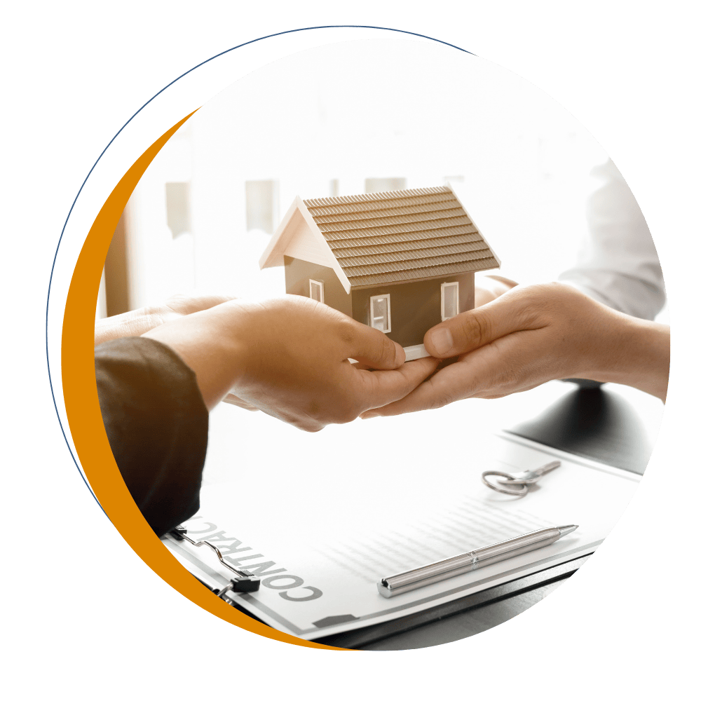 Hands passing a model home during a mortgage consultation