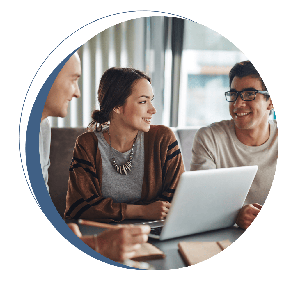 Mortgage professionals collaborating around a laptop in an office